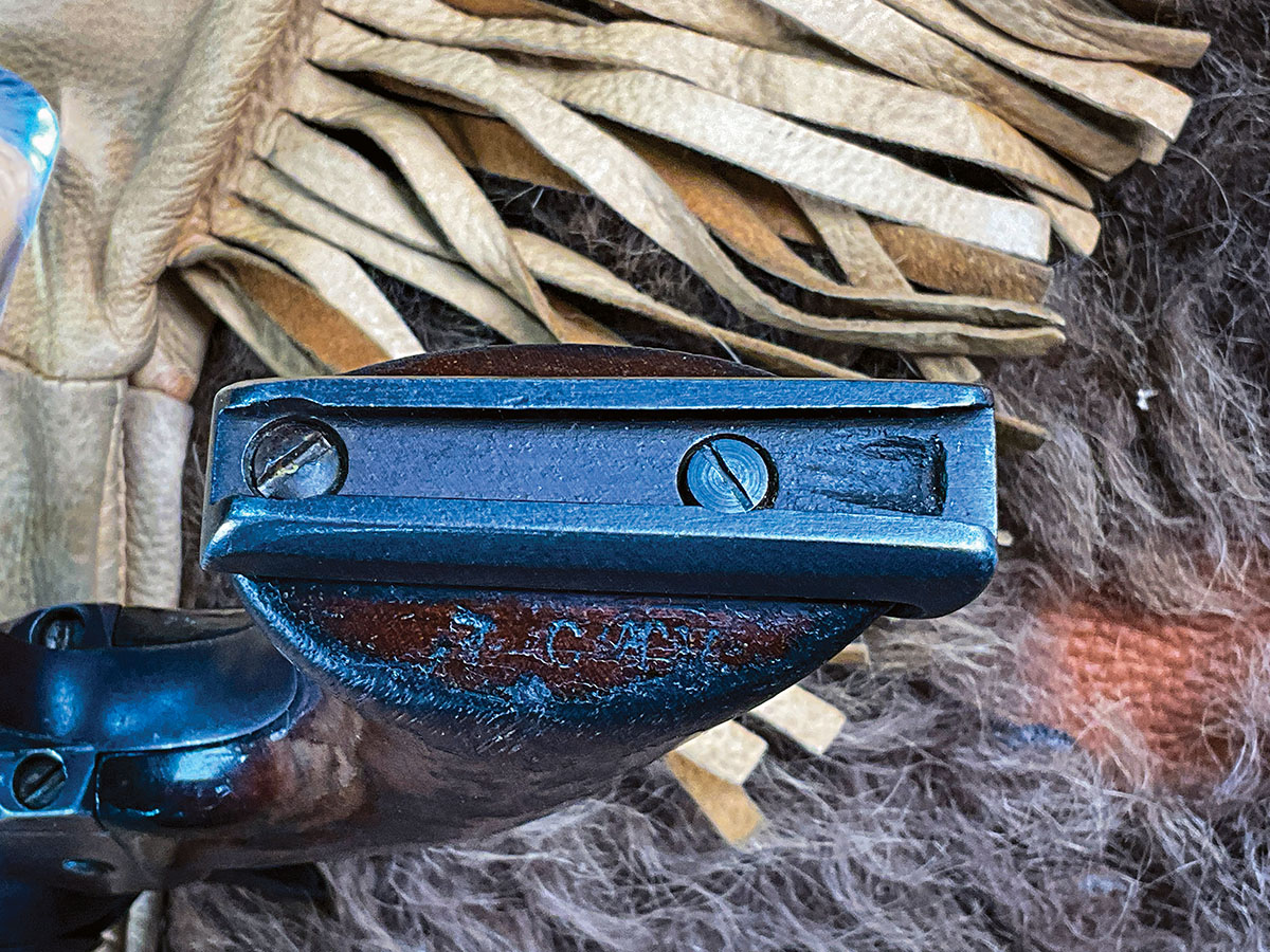 The Adams stock attachment is unique to the Bouyer Colt. A faint “7 CAV” can be seen in the end grain of the right grip.